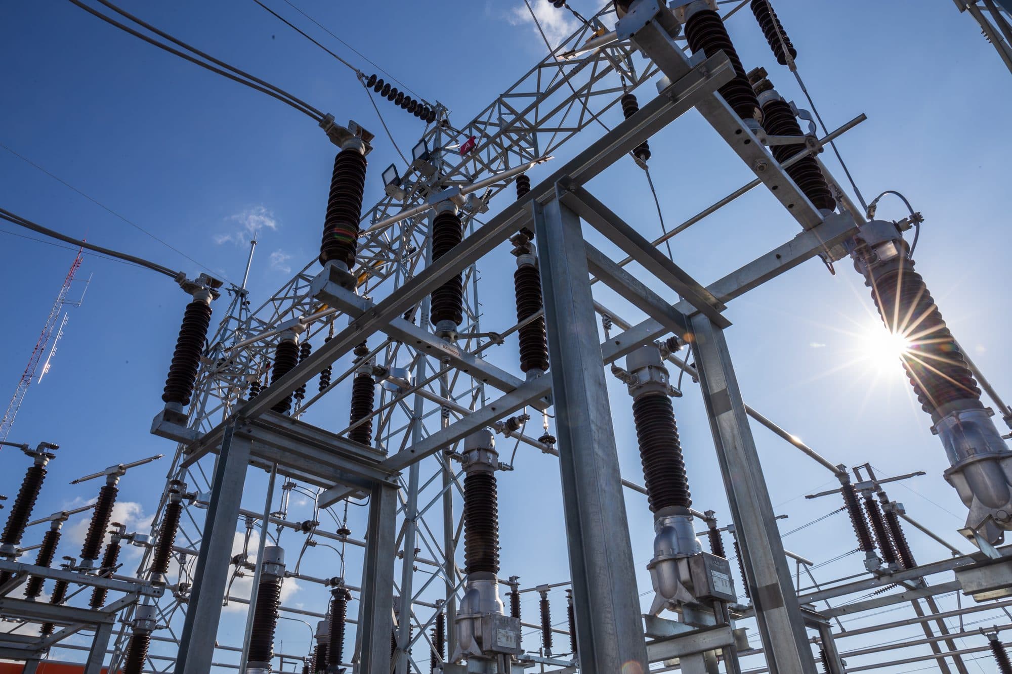Substation equipment against a clear blue sky
